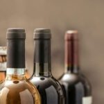 Bottles of wine in various colors and styles, featuring a blurred background, enhancing the theme of hobbies related to wine tasting and appreciation.